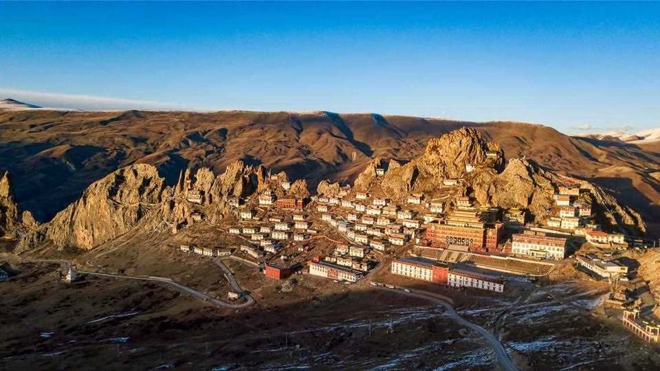 Monastery town on a hillside in Chamdo, eastern Tibet, at golden hour