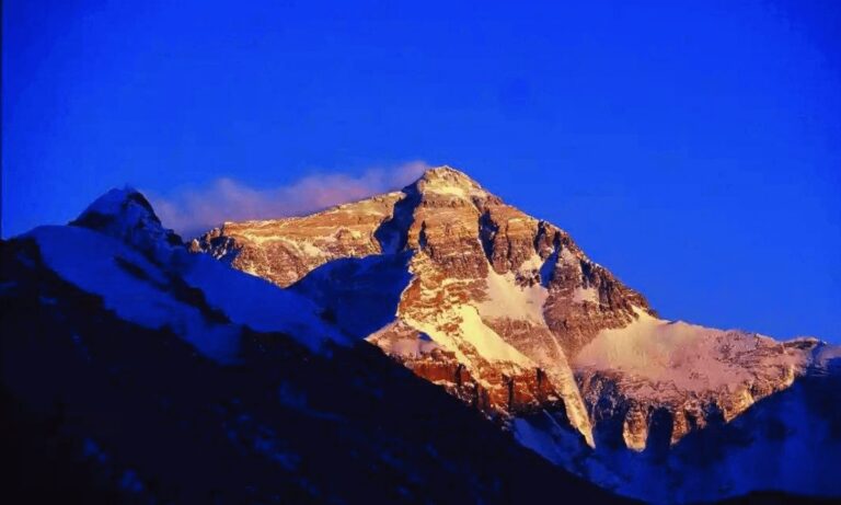 Everest glowing at sunset under a deep blue sky