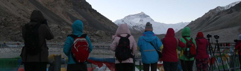 Travellers watching sunrise over Everest