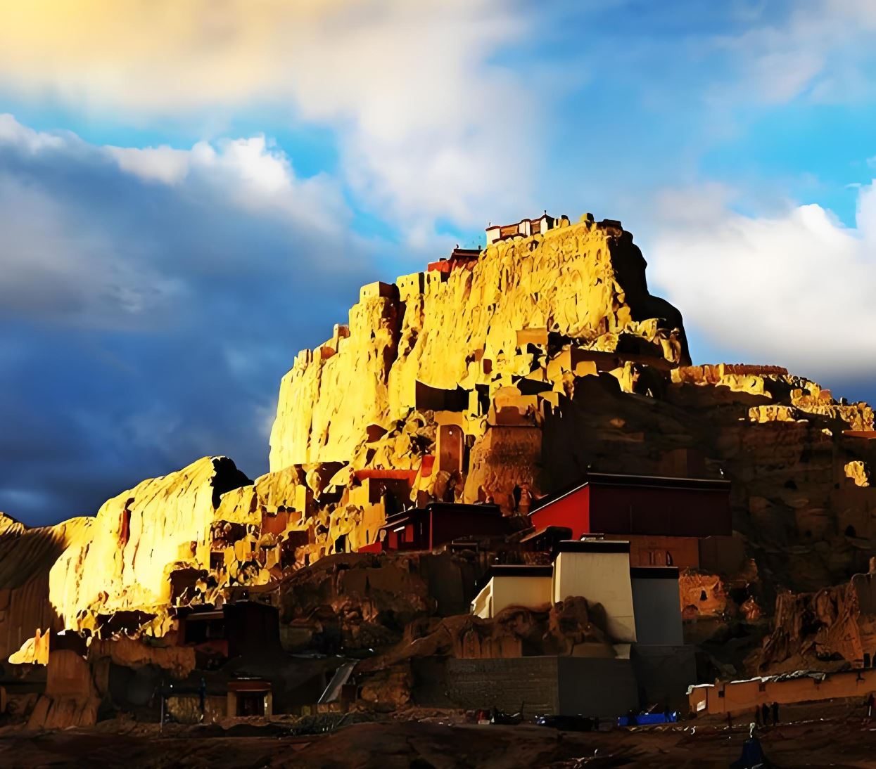 Guge Kingdom ruins lit gold at sunset, western Tibet