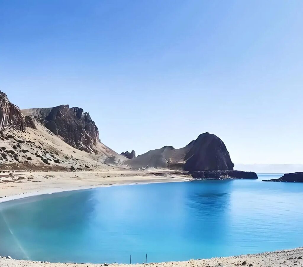 Namtso Lake shore and rock headland under blue sky