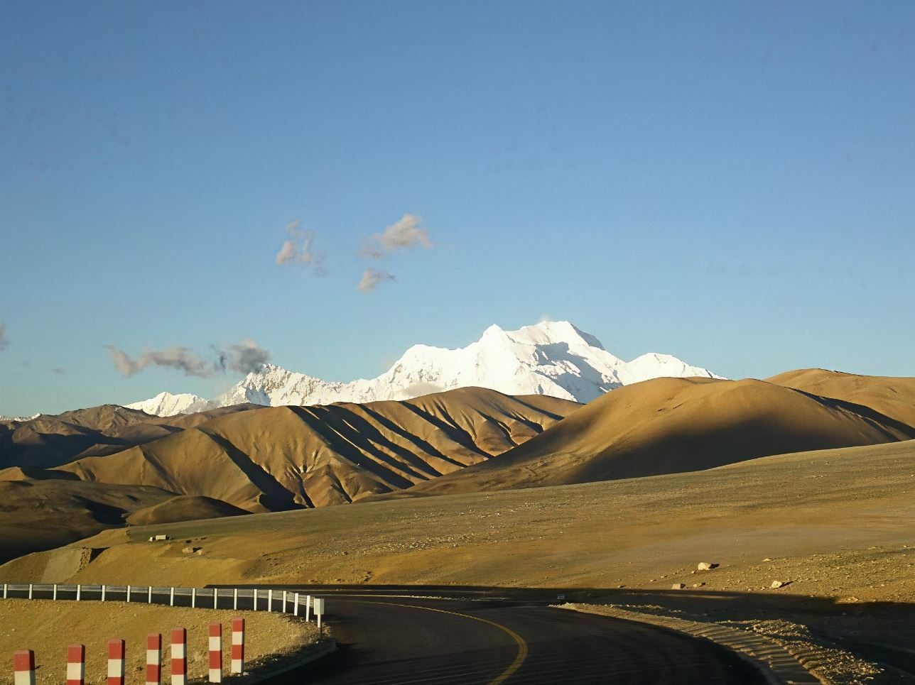 Overland road toward a snow peak in Tibet