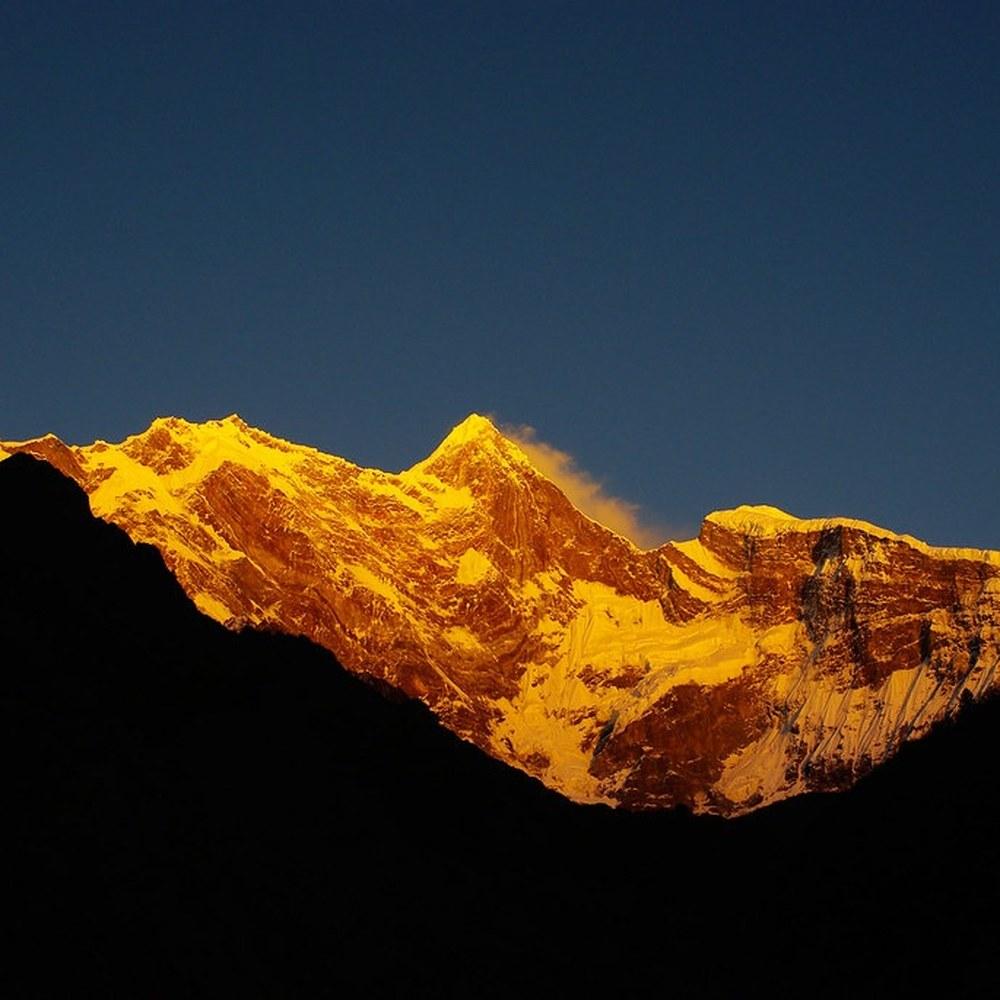 Snow peak glowing gold at dusk