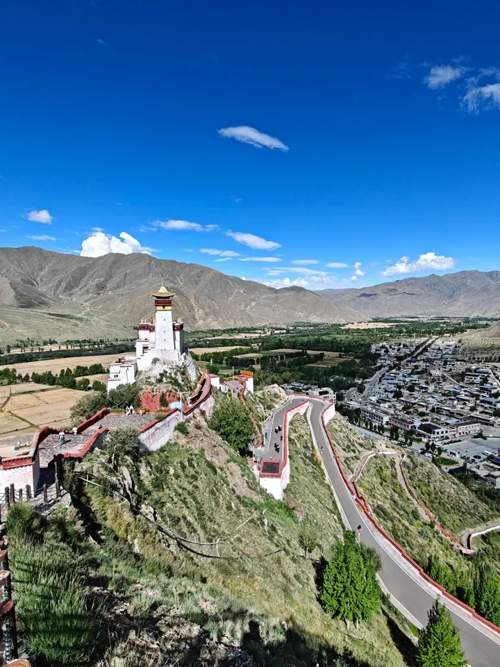 Yumbulagang Palace on its ridge above the Yarlung Valley near Tsedang, Tibet, photographed by guest Laura in August 2026